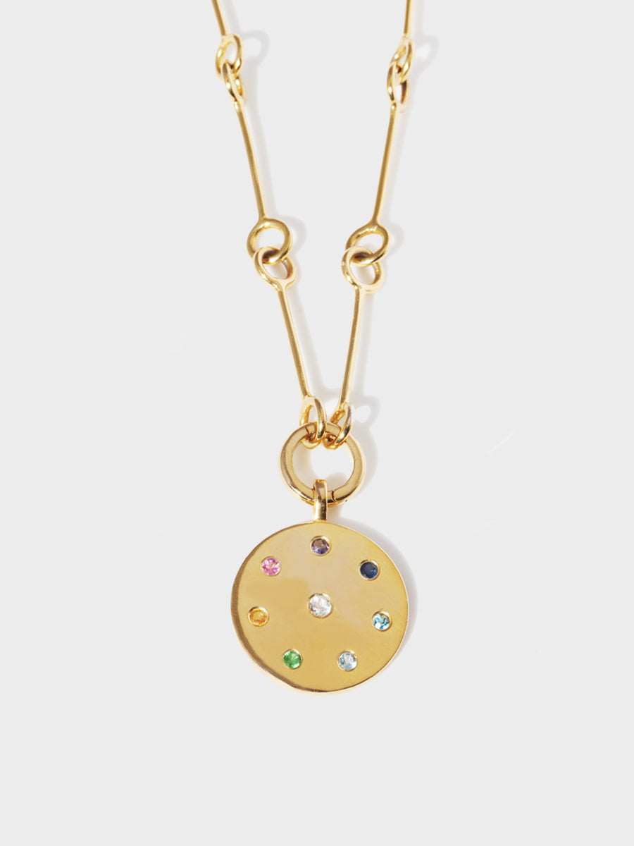 A gold link chain with a gold multi gemstone pendant with 8 different coloured stones set in a circle and one centrally