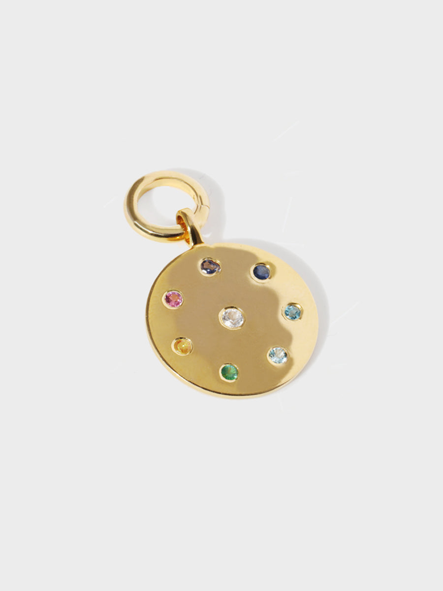 A gold necklace pendant with 7 multi coloured gemstones circling a single white central stone with a clicker connector attached