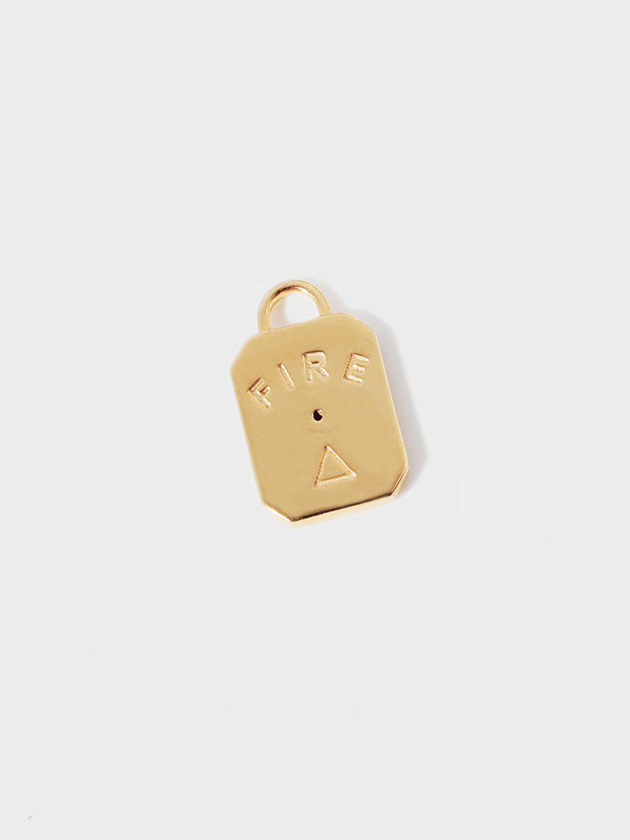 A gold air element rectangular charm with chamfered corners and the word FIRE and large connection hoop at the top. Grey background with shadow