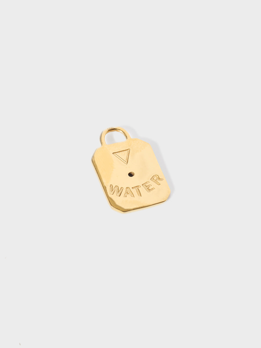 A gold air element rectangular charm with chamfered corners and with the word WATER and large connection hoop at the top. Grey background with shadow