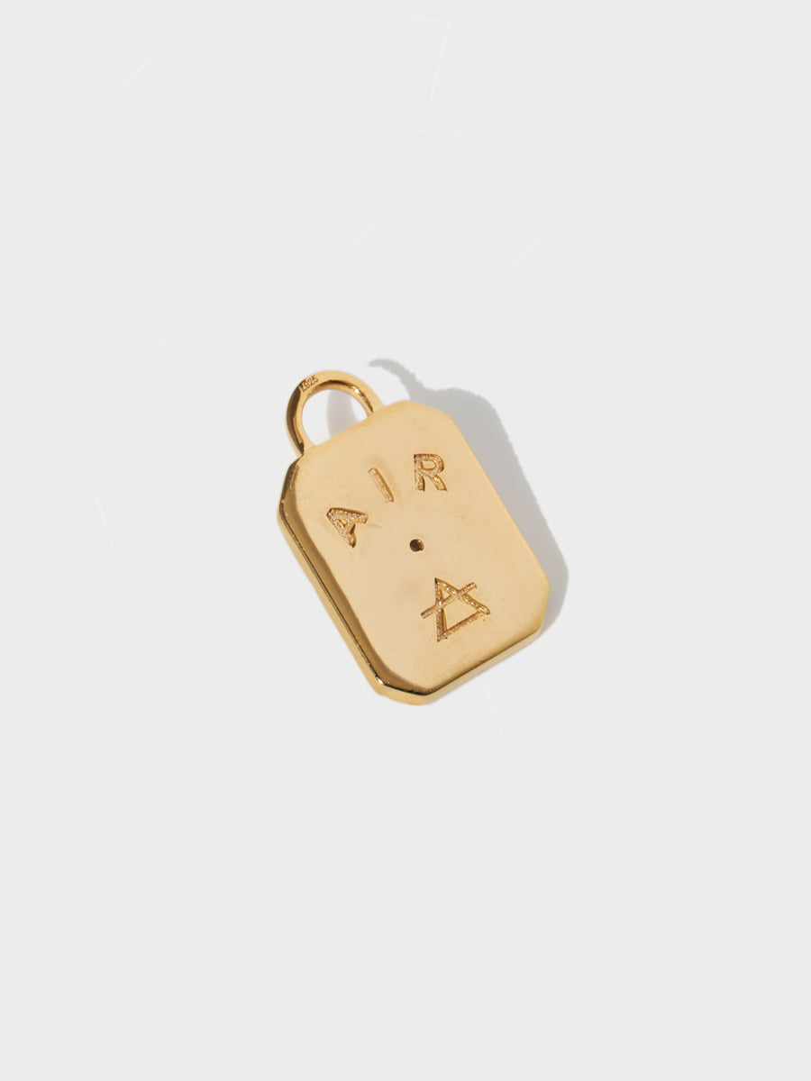 A gold air element rectangular charm with chamfered corners and the word AIR and large connection hoop at the top. Grey background with shadow