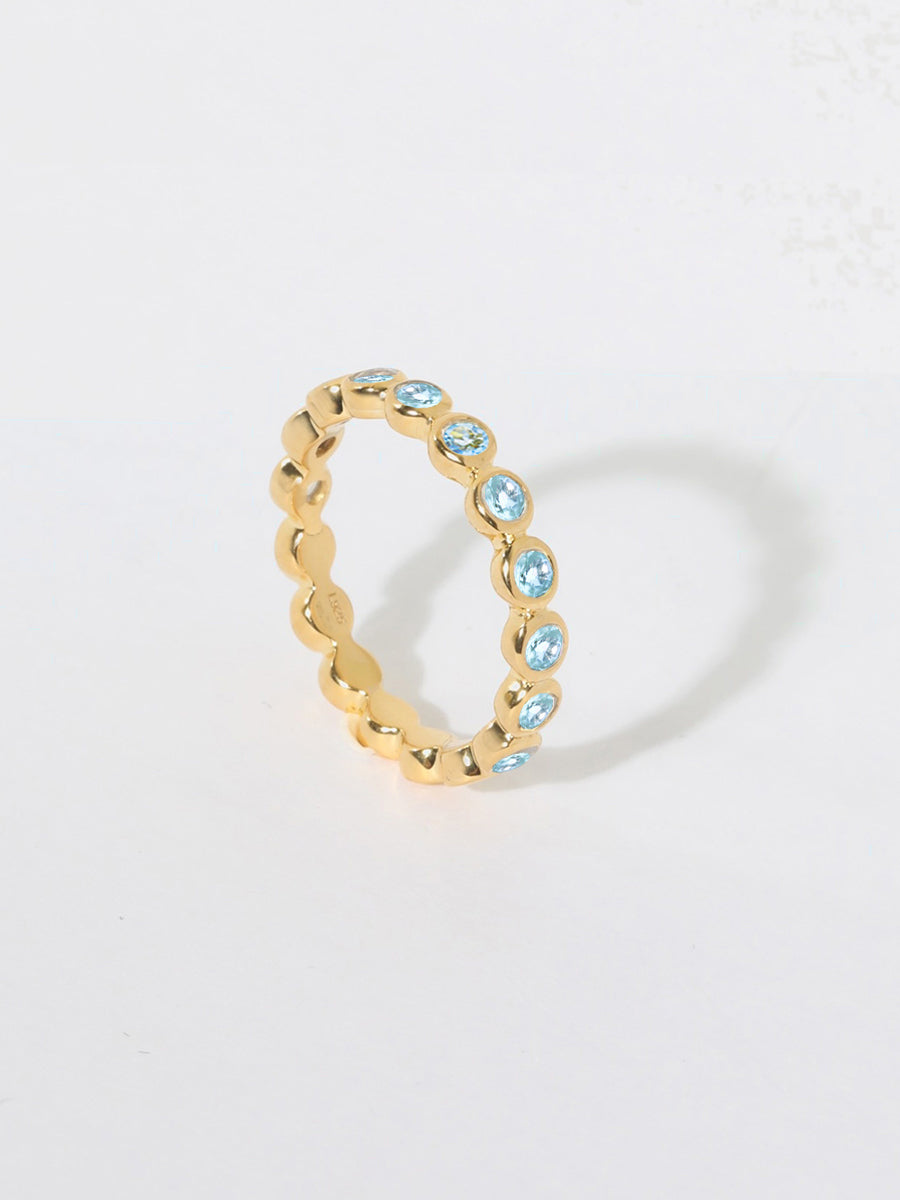 Orbit Gold Blue Topaz Eternity Ring