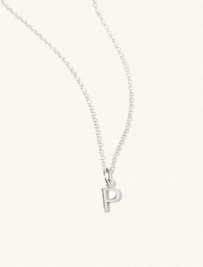 A sterling silver chain necklace with the caplital letter P approximately 8mm x 6mm. Set on a cream background with gentle shadowing.