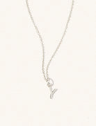 A sterling silver chain necklace with the caplital letter Y approximately 8mm x 6mm. Set on a cream background with gentle shadowing.