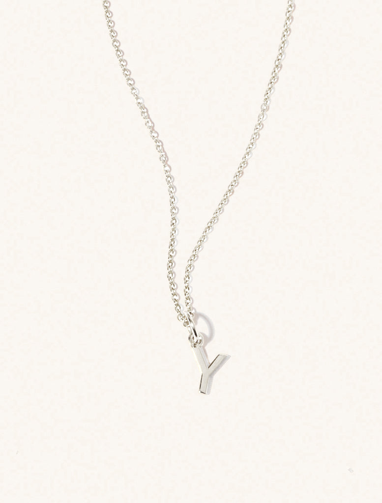 A sterling silver chain necklace with the caplital letter Y approximately 8mm x 6mm. Set on a cream background with gentle shadowing.