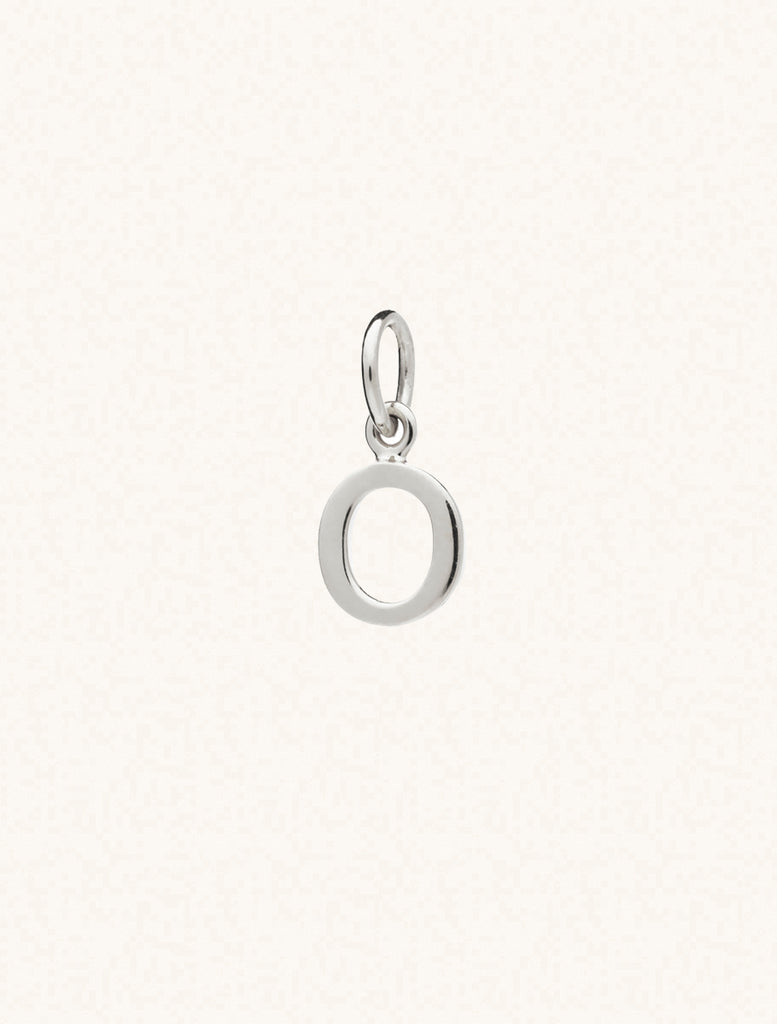 A sterling silver caplital letter O approximately 8mm x 6mm with a connecting ring to thread through a necklace at the top. Set on a cream background.