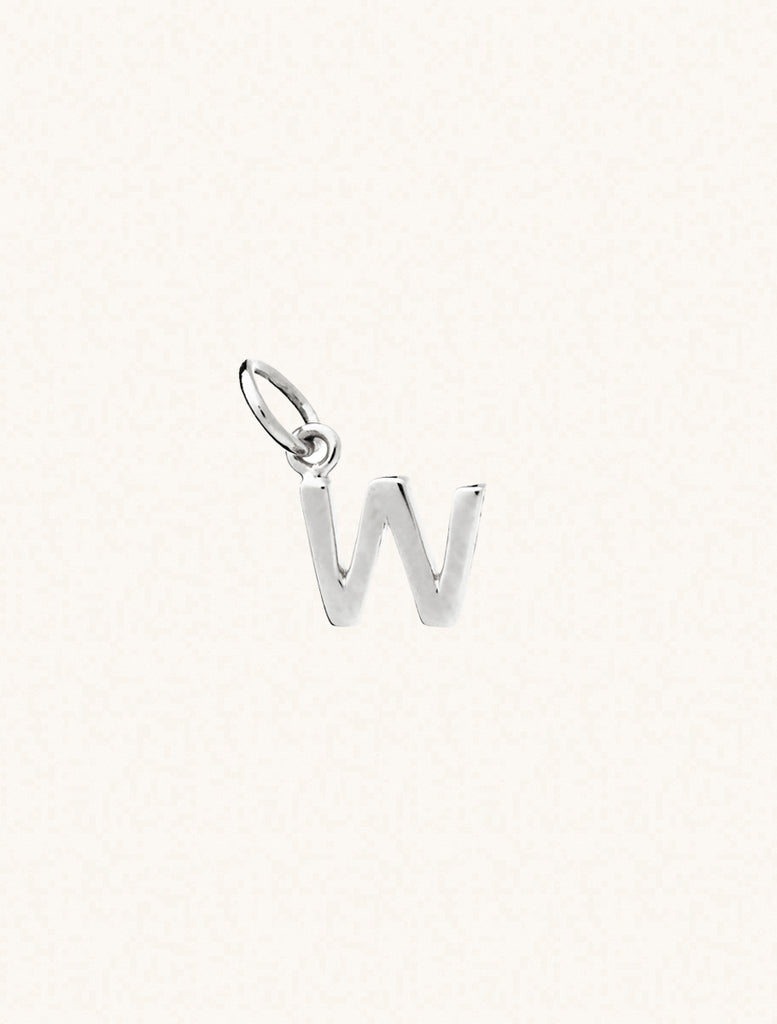 A sterling silver caplital letter W approximately 8mm x 6mm with a connecting ring to thread through a necklace at the top. Set on a cream background.