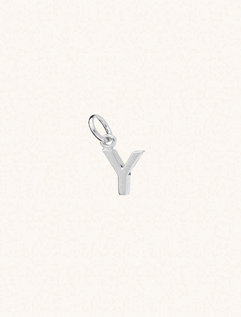 A sterling silver caplital letter Y approximately 8mm x 6mm with a connecting ring to thread through a necklace at the top. Set on a cream background.