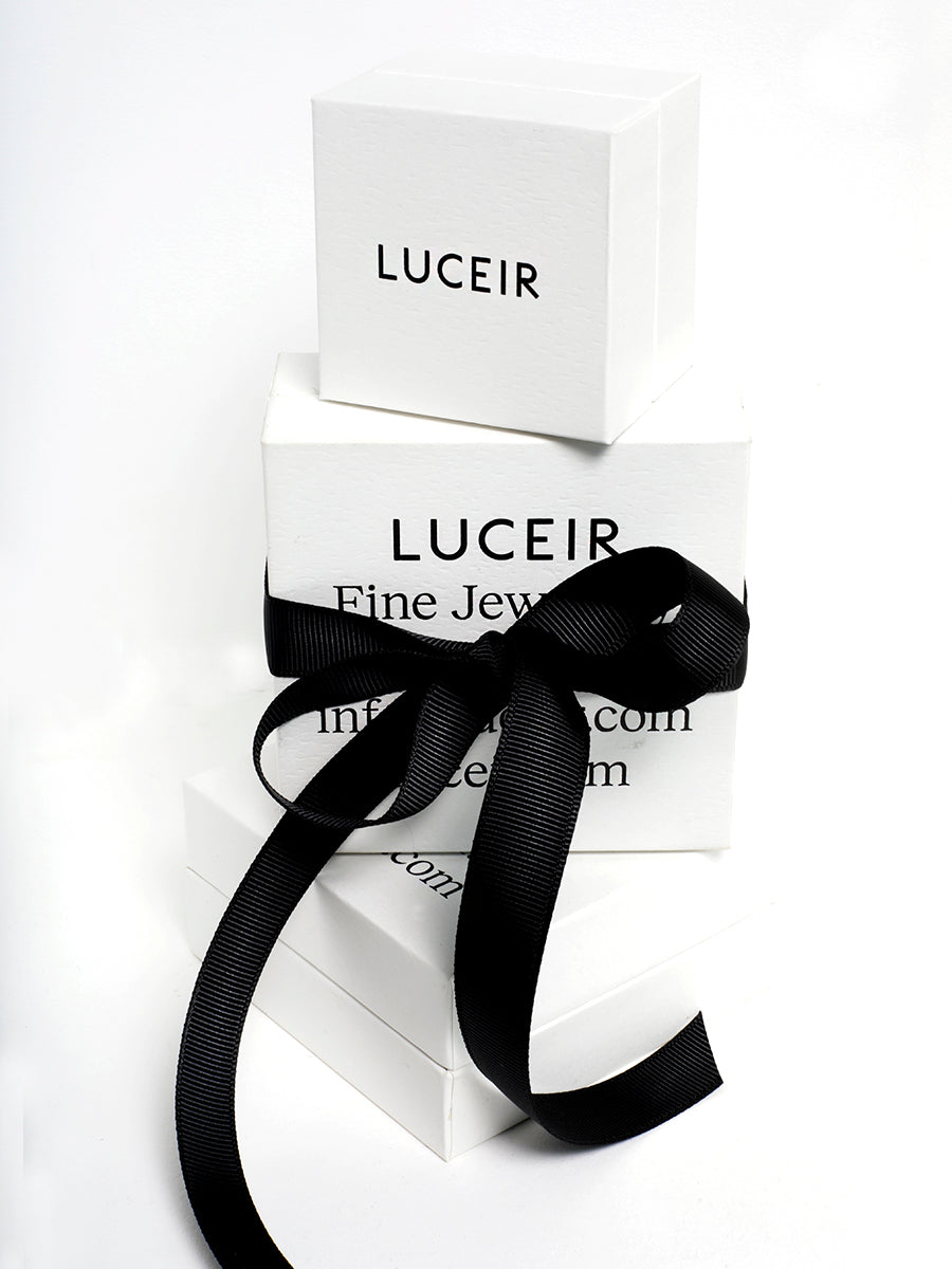 Three Luceir logo'd white boxes stacked upon each other with a black ribbon tied around the central box