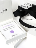 Luceir white packaging card set in a box saying Amethyst, February Birthtone, Wisdom, Passion, Hope followed by a purple circular dot symbol underneath with Luceir logo at the bottom