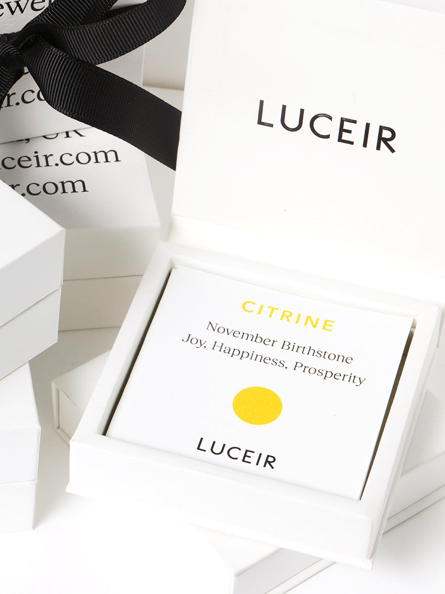 Luceir white packaging card set in a box saying Citrine, November Birthtone, Joy, Happiness, Prosperity followed by a yellow circular dot symbol underneath with Luceir logo at the bottom