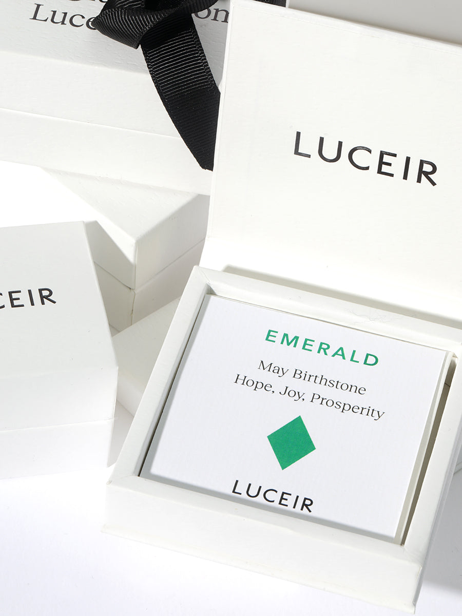 Luceir white packaging card set in a box saying Emerald, May Birthstone, Hope, Joy, Prosperity followed by an emerald green diamond symbol underneath with Luceir logo at the bottom