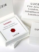 Luceir white packaging card set in a box saying Garnet, January Birthtone, Creativity, Courage, Grace followed by a dark red hexagon symbol underneath with Luceir logo at the bottom