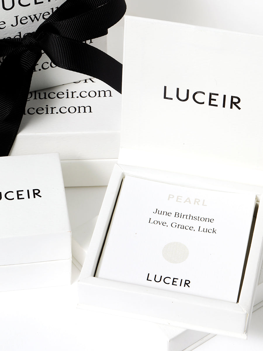 Luceir white packaging card set in a box saying Pearl, June Birthstone, Love, Grace, Luck followed by a light grey circular dot symbol underneath with Luceir logo at the bottom