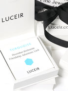 Luceir white packaging card set in a box saying Turquoise, December Birthtone, Friendship, Adventure, Luck followed by a turquoise hexagon symbol underneath with Luceir logo at the bottom